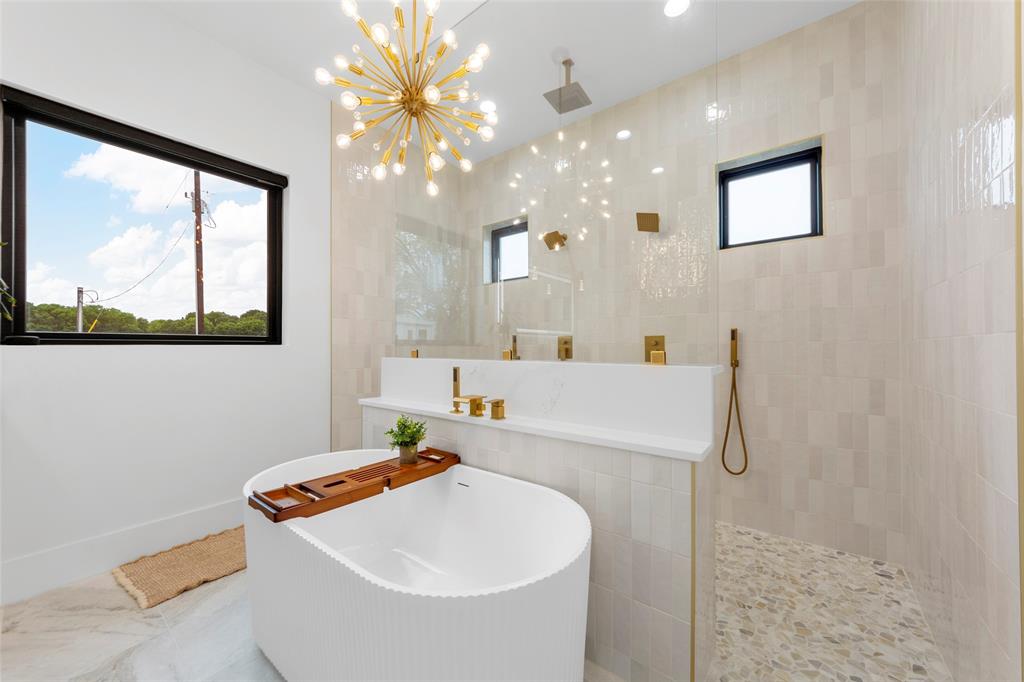 1088 Smith Oak Road Sherman, TX 75090 - Photo 24 of 39 a bathroom with a sink a large mirror and a bathtub