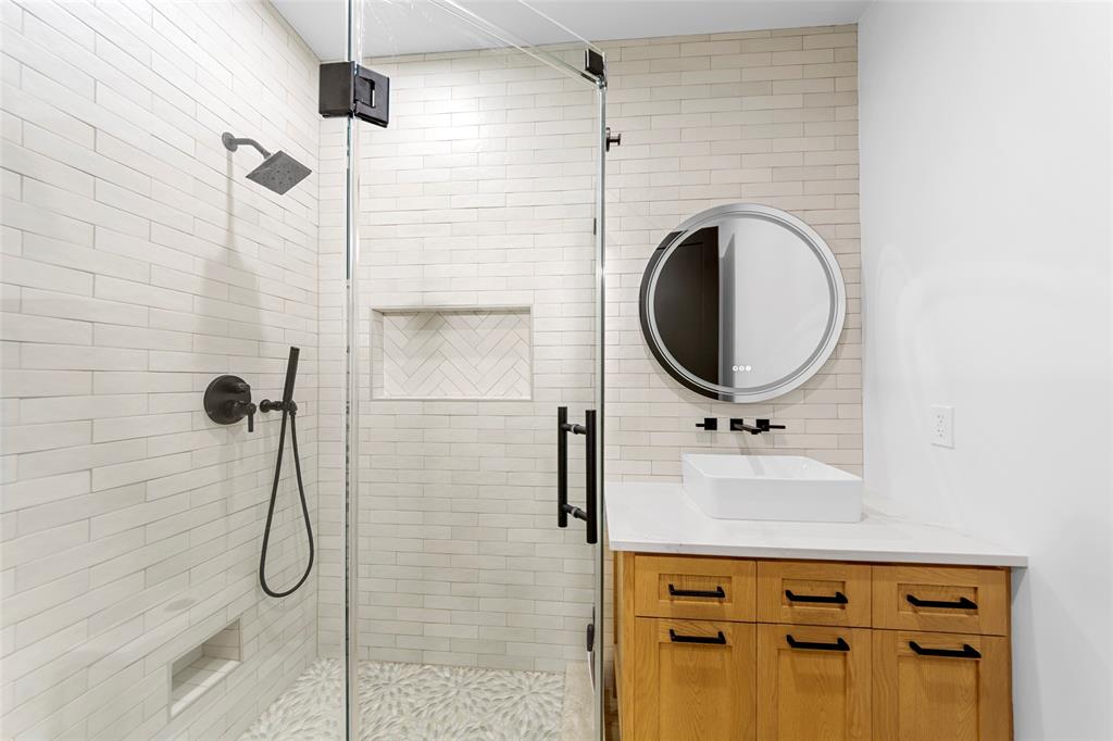 1088 Smith Oak Road Sherman, TX 75090 - Photo 28 of 39 a bathroom with a sink a mirror and shower