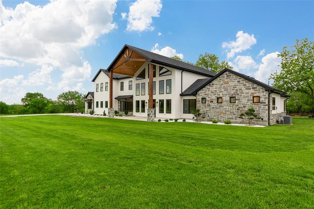 1088 Smith Oak Road Sherman, TX 75090 - Photo 7 of 39 a view of a house with a big yard potted plants and large tree