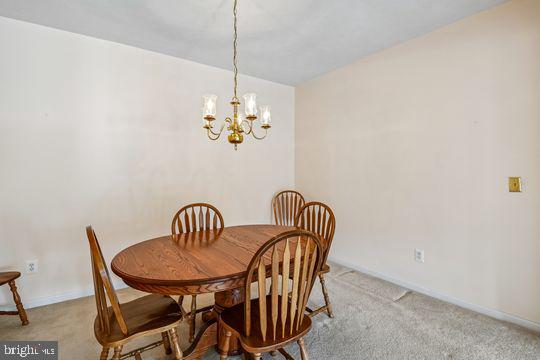 9511 Kingscroft Terrace, Unit 9511F Perry Hall, MD 21128 - Photo 11 of 38 a view of a dining room with furniture and chandelier