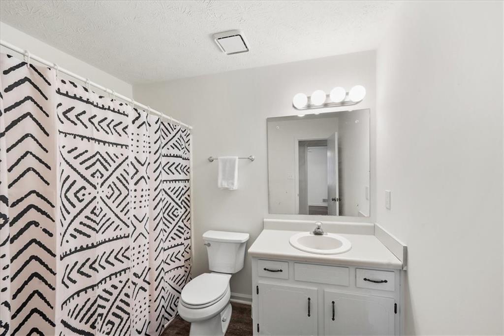2561 Ripple Way Lawrenceville, GA 30043 - Photo 9 of 19 a bathroom with a sink toilet and mirror