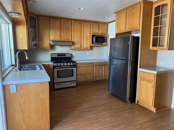 a kitchen with a refrigerator sink and stove