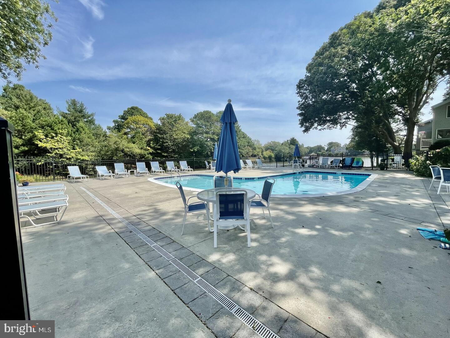 11 Newbold Square, Unit 11 Rehoboth Beach, DE 19971 - Photo 14 of 21 a swimming pool with outdoor seating and yard