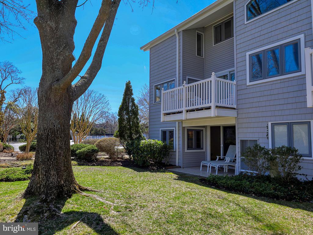 11 Newbold Square, Unit 11 Rehoboth Beach, DE 19971 - Photo 2 of 21 a front view of a house with garden