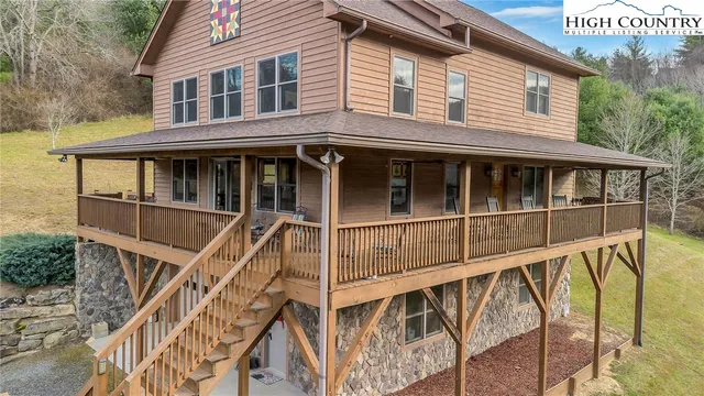 a view of a house with pool and deck