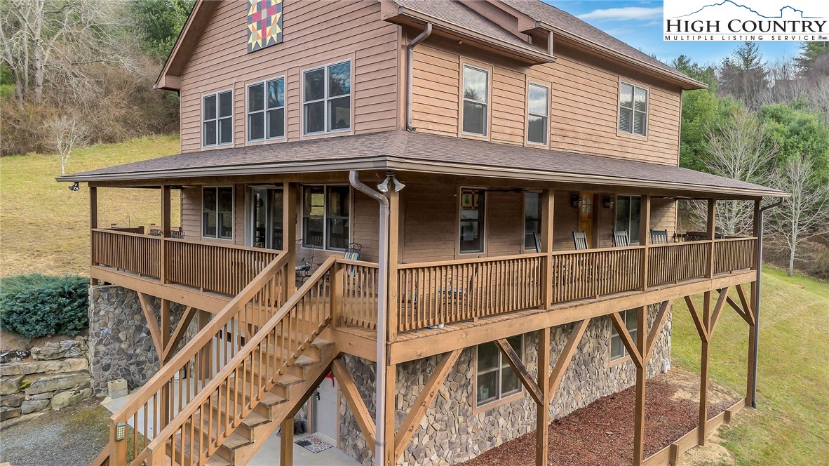 a view of a house with pool and deck