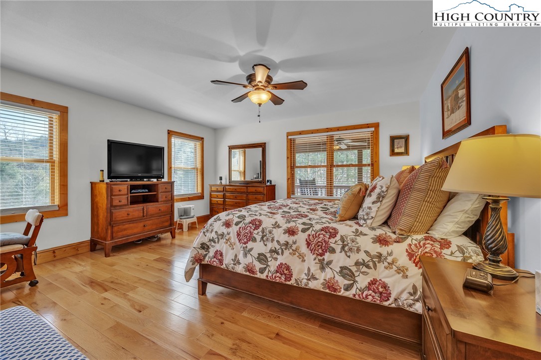 1118 Lucy Bell Road Crumpler, NC 28617 - Photo 12 of 39 a bedroom with a bed a couch and a flat tv screen on a table