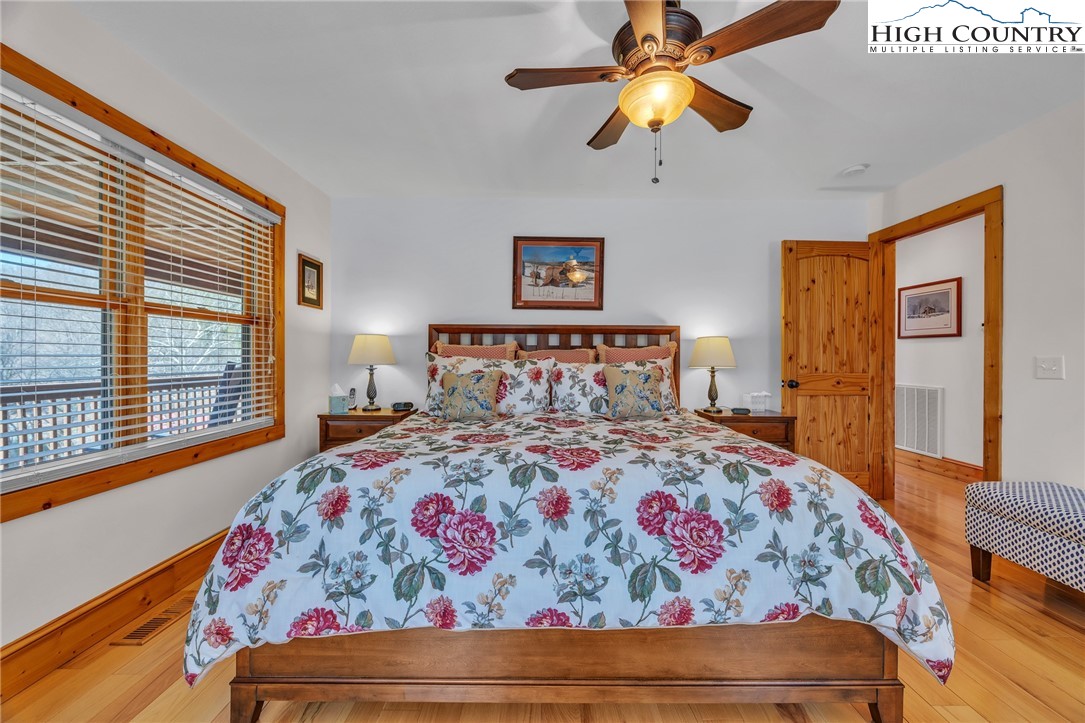 1118 Lucy Bell Road Crumpler, NC 28617 - Photo 13 of 39 a bedroom with a bed and a chandelier