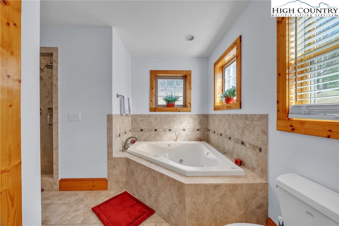 1118 Lucy Bell Road Crumpler, NC 28617 - Photo 15 of 39 a bathroom with a bathtub and a sink