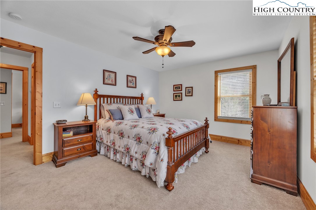 1118 Lucy Bell Road Crumpler, NC 28617 - Photo 21 of 39 a bedroom with a bed and a chandelier