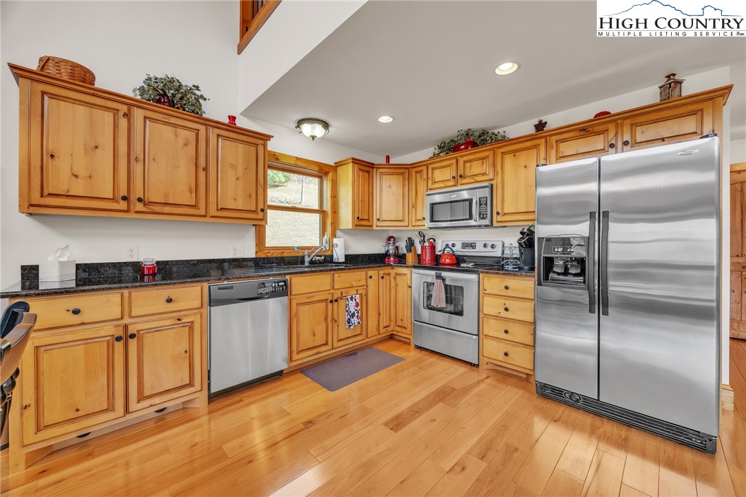 1118 Lucy Bell Road Crumpler, NC 28617 - Photo 10 of 39 a kitchen with granite countertop stainless steel appliances a refrigerator sink cabinets and microwave