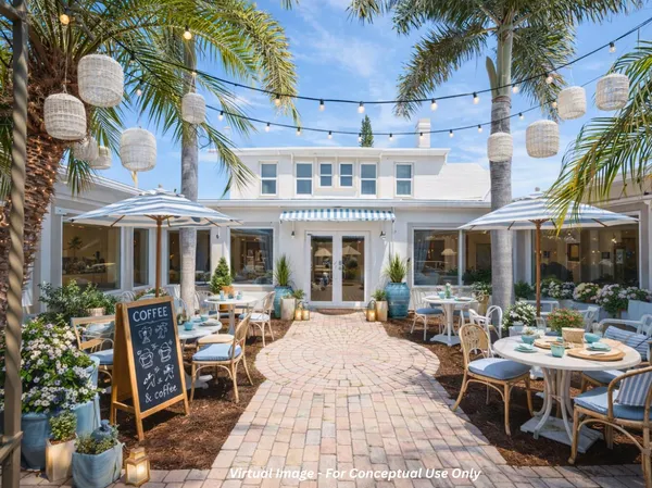a view of a building with sitting area and furniture