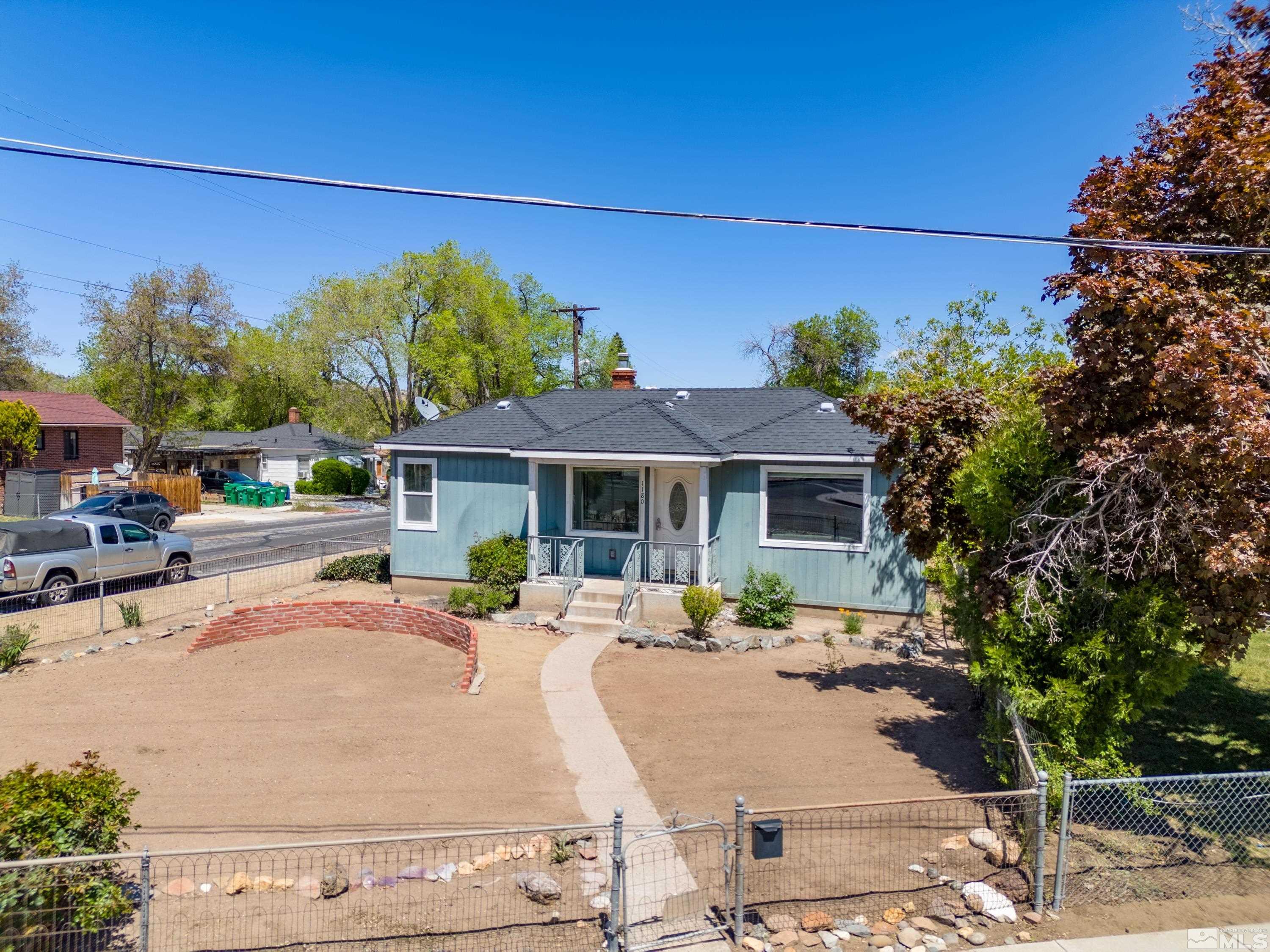 1180 Codel Way Reno, NV 89503 - Photo 38 of 39 a view of a patio with couches and table and chairs under an umbrella