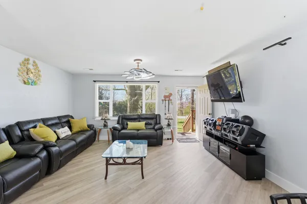 a kitchen with stainless steel appliances a dining table chairs stove and refrigerator