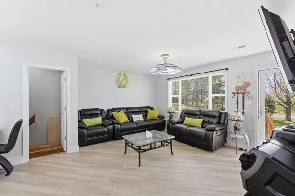 a kitchen with stainless steel appliances granite countertop a sink dishwasher and cabinets with wooden floor