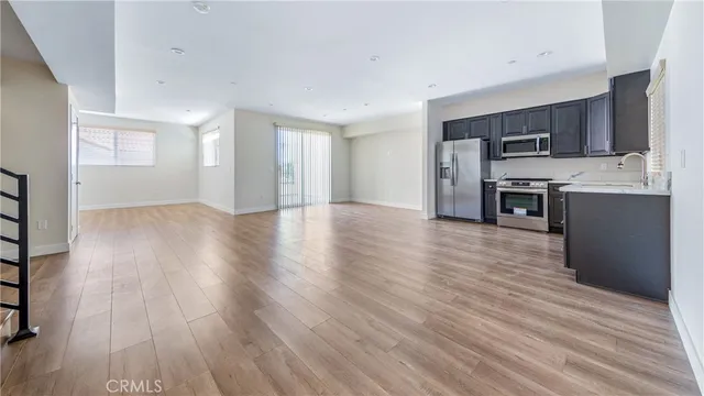 a view of a kitchen with a sink a refrigerator and window