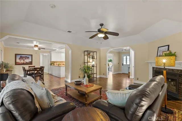 a living room with furniture a fireplace and a large window