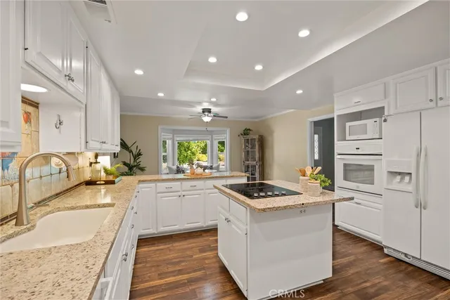 a large bedroom with a bed and a chandelier