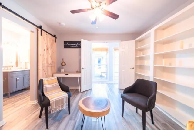 a living room with furniture and a large window