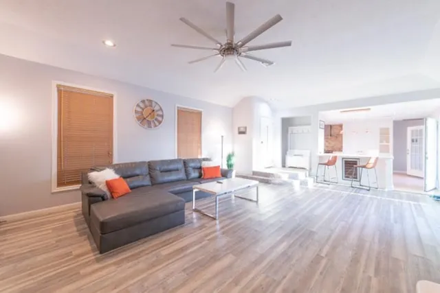 a living room with furniture and wooden floor