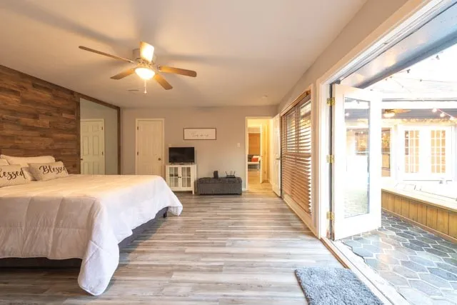 a spacious bedroom with a large bed and a chandelier