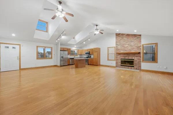 a view of a livingroom with furniture a ceiling fan window and fireplace