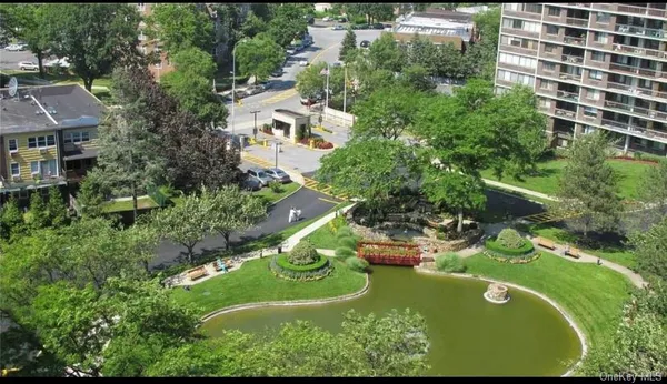 an aerial view of a house with a garden and lake view