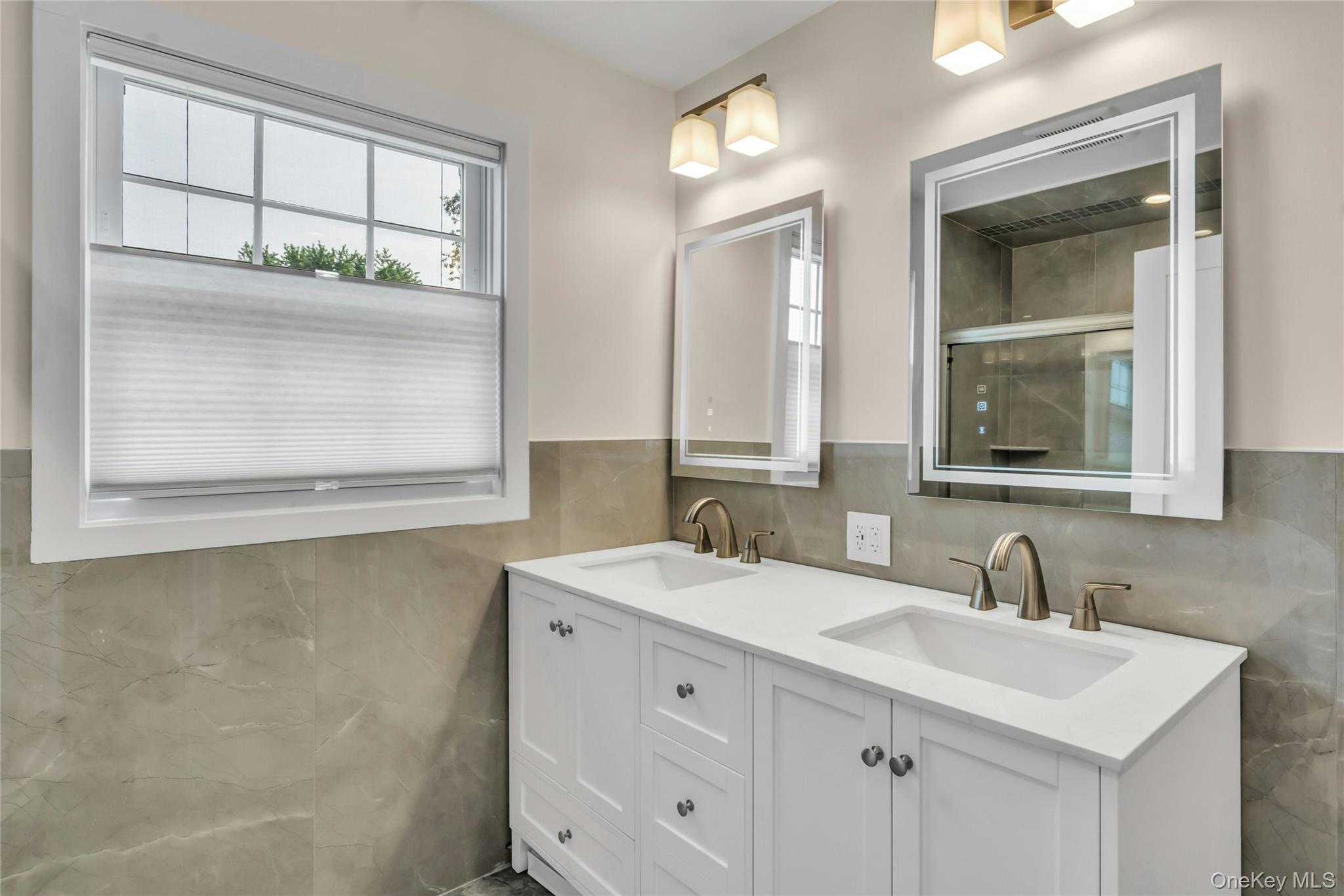 20 Robert Road Glen Cove, NY 11542 - Photo 16 of 23 New bath with recessed lighting plus custom overhead lighting and custom cabinetry and commode.