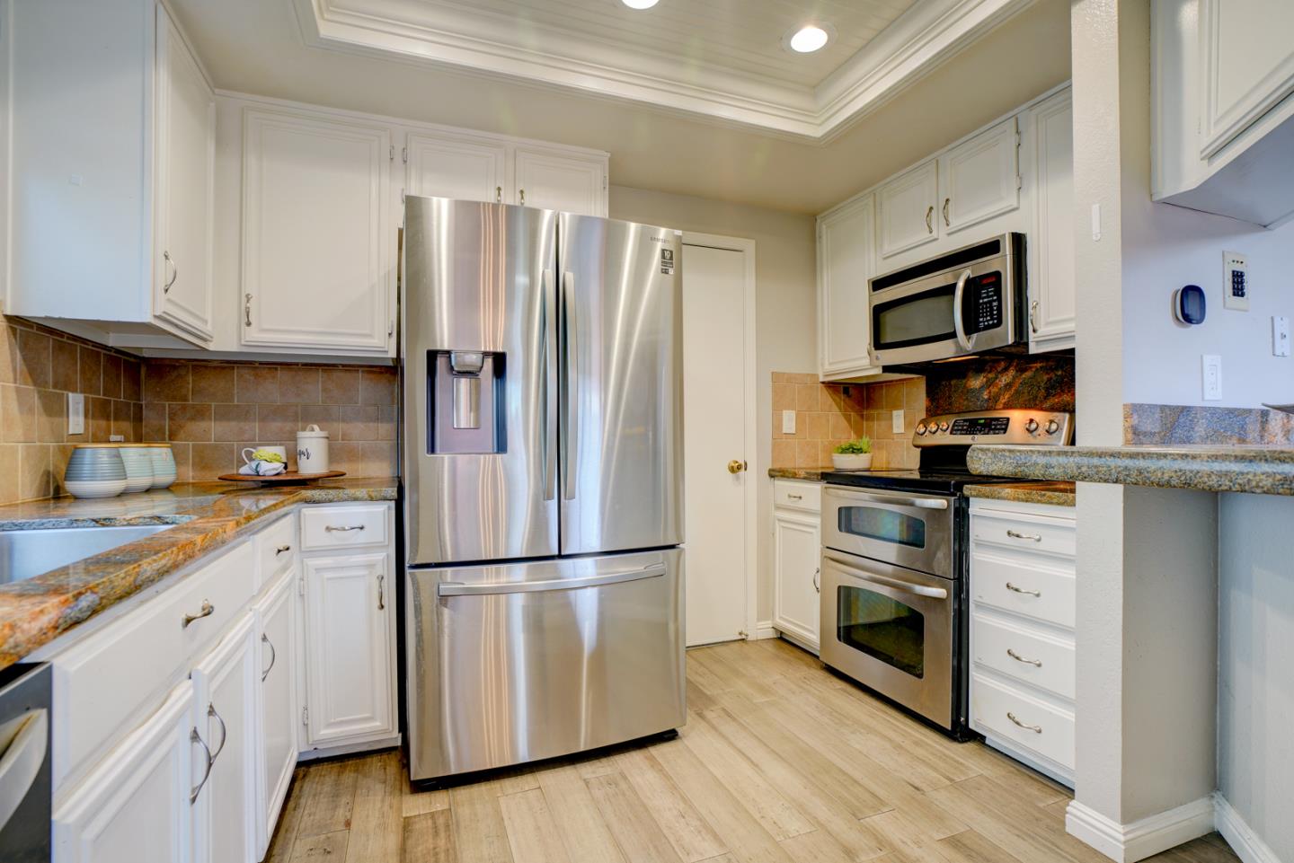 44 Redding Road Campbell, CA 95008 - Photo 8 of 51 a kitchen with cabinets stainless steel appliances and wooden floor