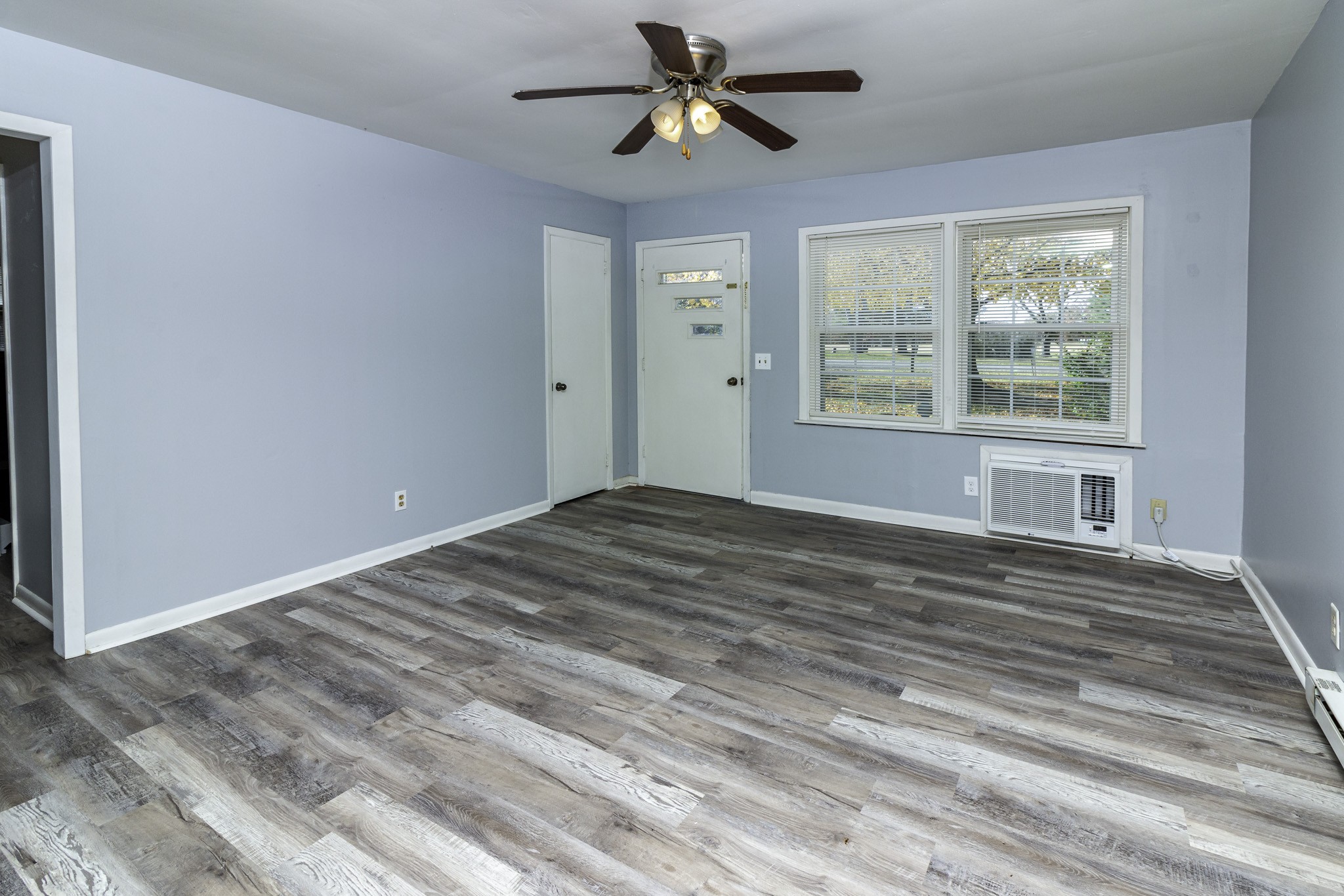 121 Glenn Springs Road Lawrenceburg, TN 38464 - Photo 3 of 17 a view of empty room with wooden floor and fan