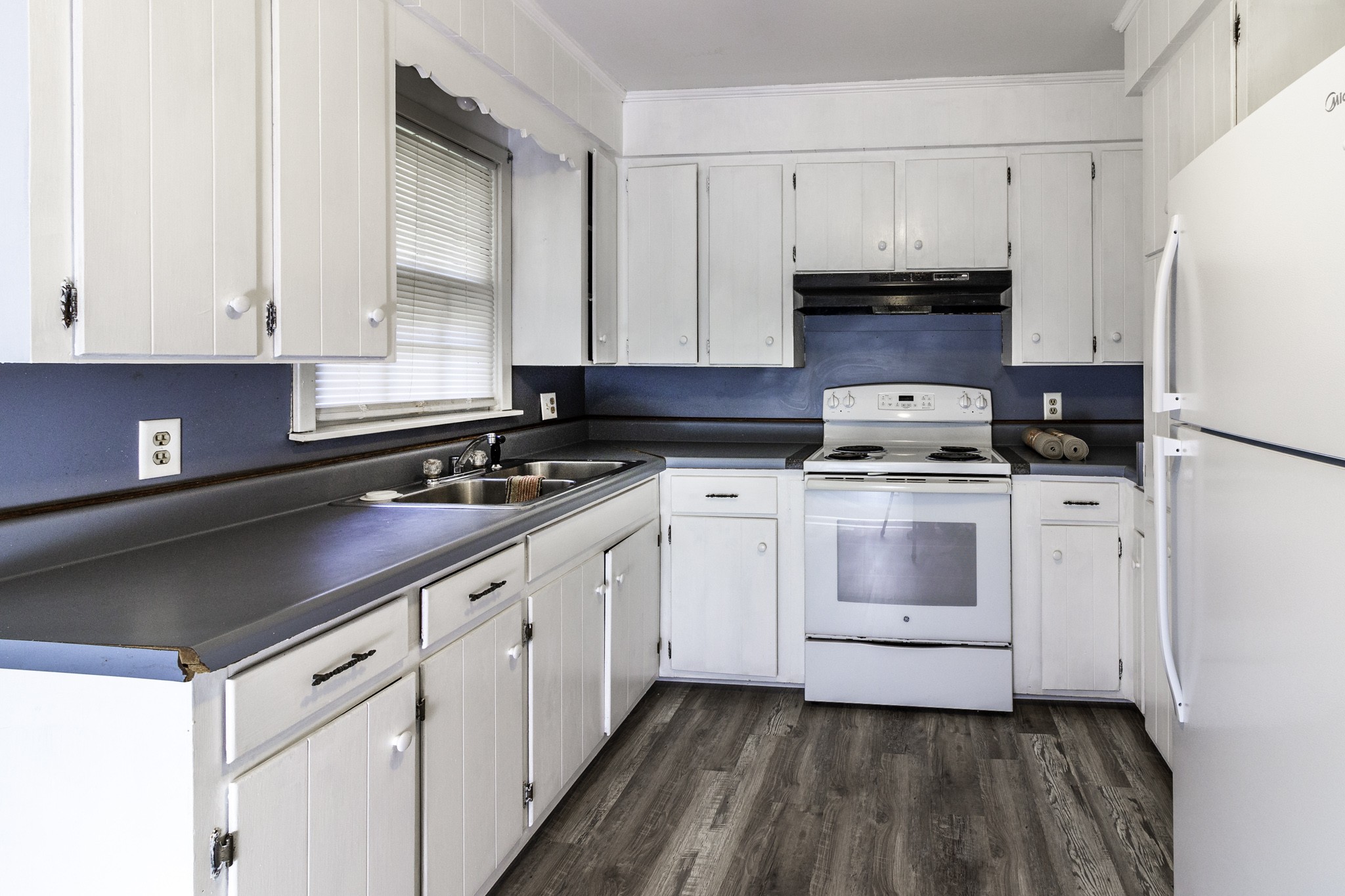 121 Glenn Springs Road Lawrenceburg, TN 38464 - Photo 4 of 17 a kitchen with white cabinets sink and white appliances