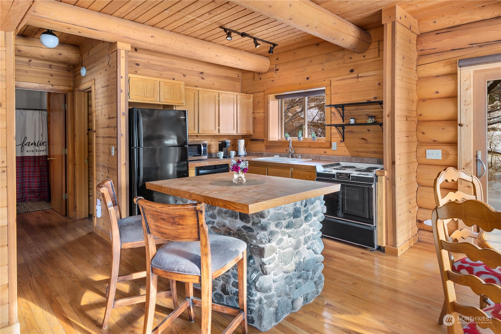 3435 Teanaway Road Cle Elum, WA 98922 - Photo 19 of 33 a kitchen with stainless steel appliances granite countertop a table chairs stove and refrigerator