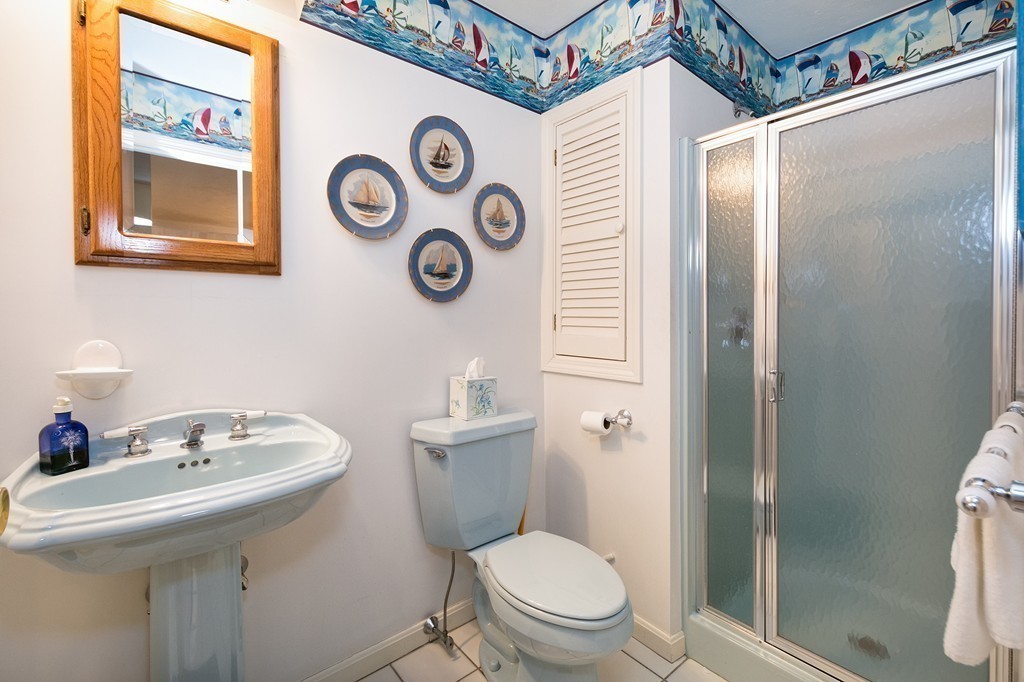 40 Driftway, Unit 13 Scituate, MA 02066 - Photo 16 of 29 a bathroom with a sink and a toilet
