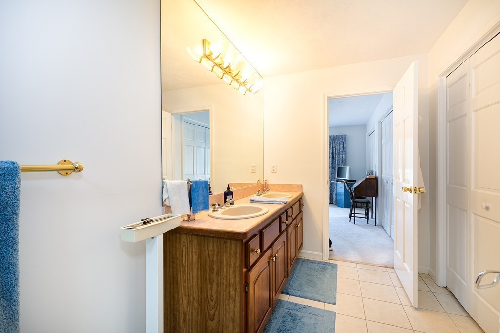 40 Driftway, Unit 13 Scituate, MA 02066 - Photo 20 of 29 a bathroom with a sink a mirror and a shower