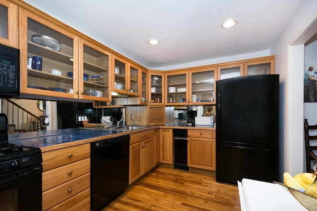 40 Driftway, Unit 13 Scituate, MA 02066 - Photo 6 of 29 a kitchen with stainless steel appliances granite countertop a refrigerator and a stove top oven
