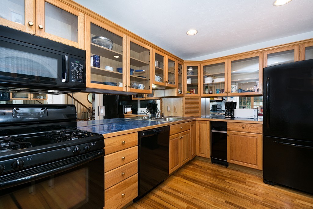 40 Driftway, Unit 13 Scituate, MA 02066 - Photo 8 of 29 a kitchen with stainless steel appliances granite countertop a refrigerator and a stove top oven