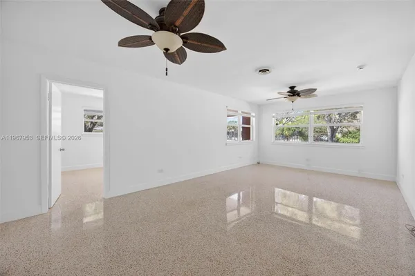 a view of a kitchen with furniture and a ceiling fan