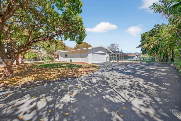 a large tree in front of a house