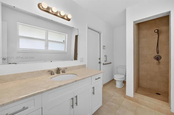 a bathroom with a sink a vanity and a mirror