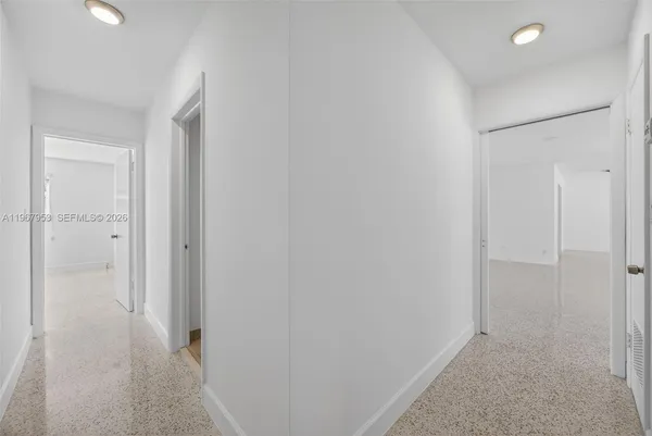 a bathroom with a granite countertop toilet and a shower