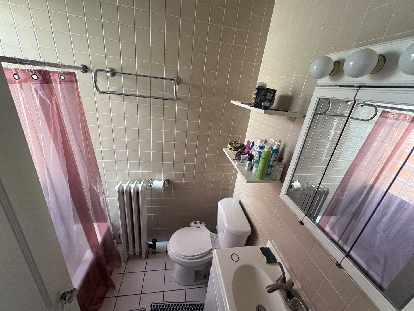 1529 Greenleaf Street Evanston, IL 60202 - Photo 11 of 15 a white toilet sitting next to a shower curtain