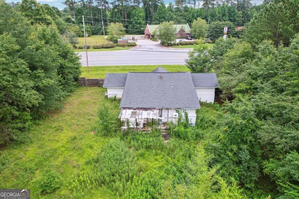 an aerial view of a house with a big yard