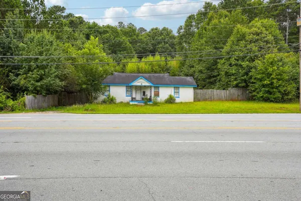 a house with a yard and a large parking space