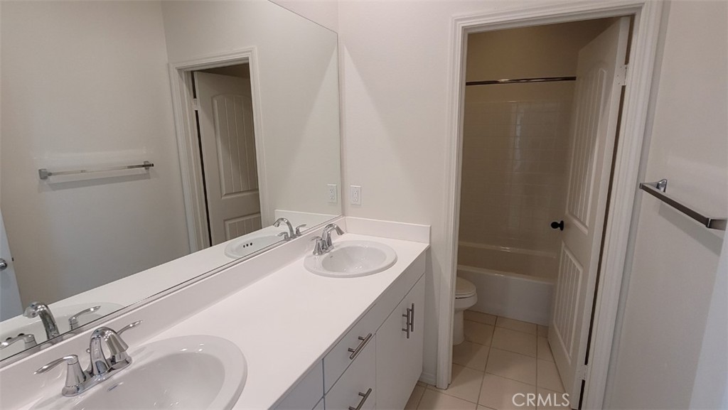 22056 Windham Way Saugus, CA 91350 - Photo 14 of 35 a bathroom with a sink and a mirror