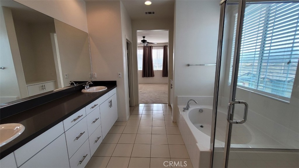 22056 Windham Way Saugus, CA 91350 - Photo 21 of 35 a spacious bathroom with a granite countertop sink a toilet a mirror and shower
