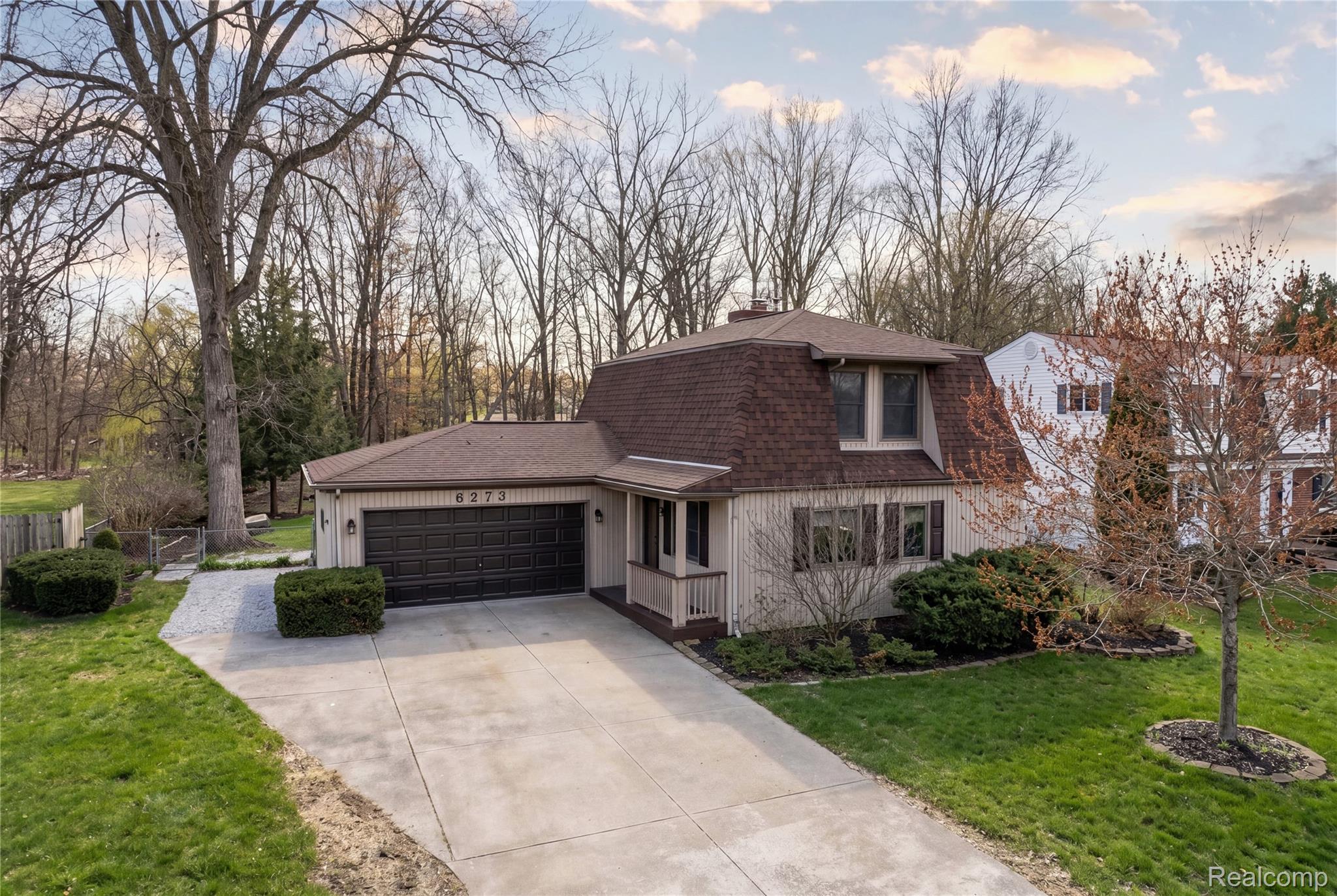 6273 Cold Spring Trail Grand Blanc, MI 48439 - Photo 1 of 48 View of front of property featuring an attached garage, roof with shingles, a front yard, a chimney, and driveway