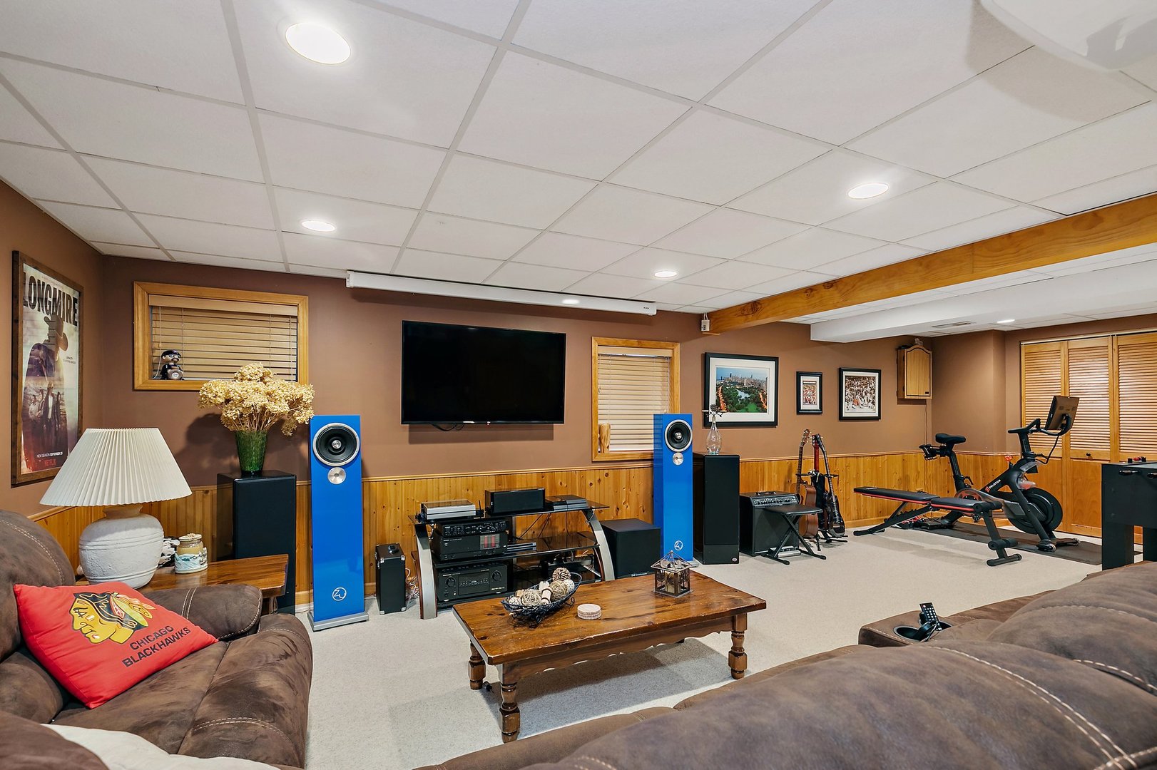 1010 Wakefield Drive Elgin, IL 60120 - Photo 21 of 32 a living room with furniture gym equipment and a flat screen tv