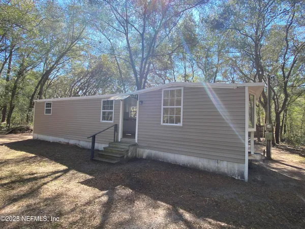 a backyard of a house with table and chairs