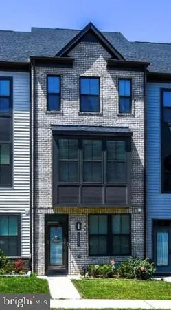 a view of a house with a yard and large windows