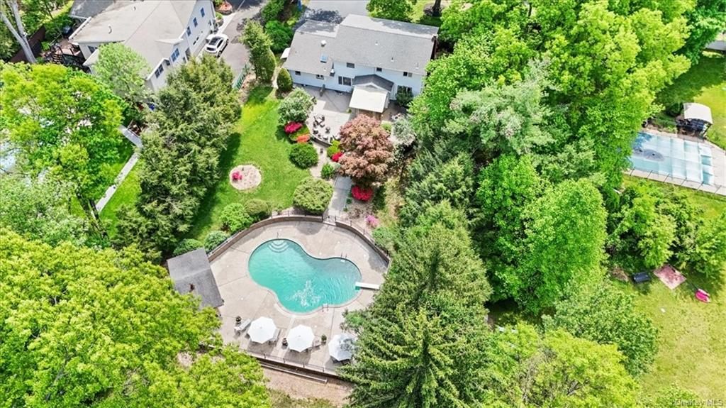 an aerial view of a house with a swimming pool and garden view